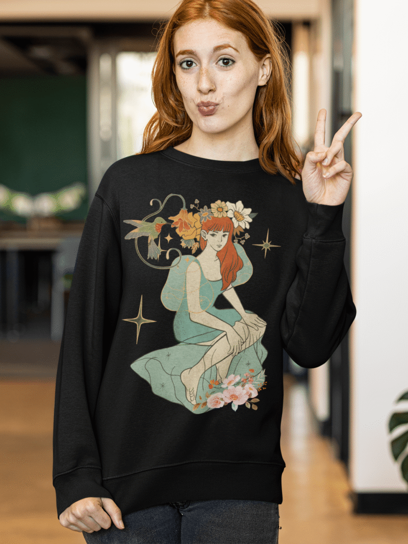 A black Women’s Nature Muse Sweatshirt with a vintage look from PodLyft, featuring a DTG-printed nature-inspired design with floral and leafy patterns on the front, displayed against a white background.