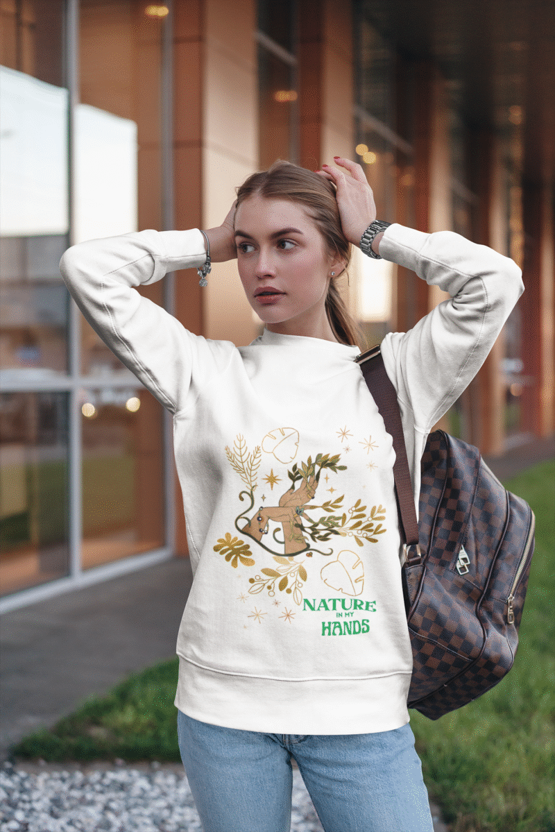 A white Women’s Nature Muse Sweatshirt with a vintage look from PodLyft, featuring a DTG-printed nature-inspired design with floral and leafy patterns on the front, shown against a white background.
