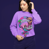 A woman wearing a vibrant light purple PodLyft Feminist Power Sweatshirt, featuring a bold graphic with a female symbol, a lotus flower, a raised fist, and the text "HERSTORY IN THE MAKING.