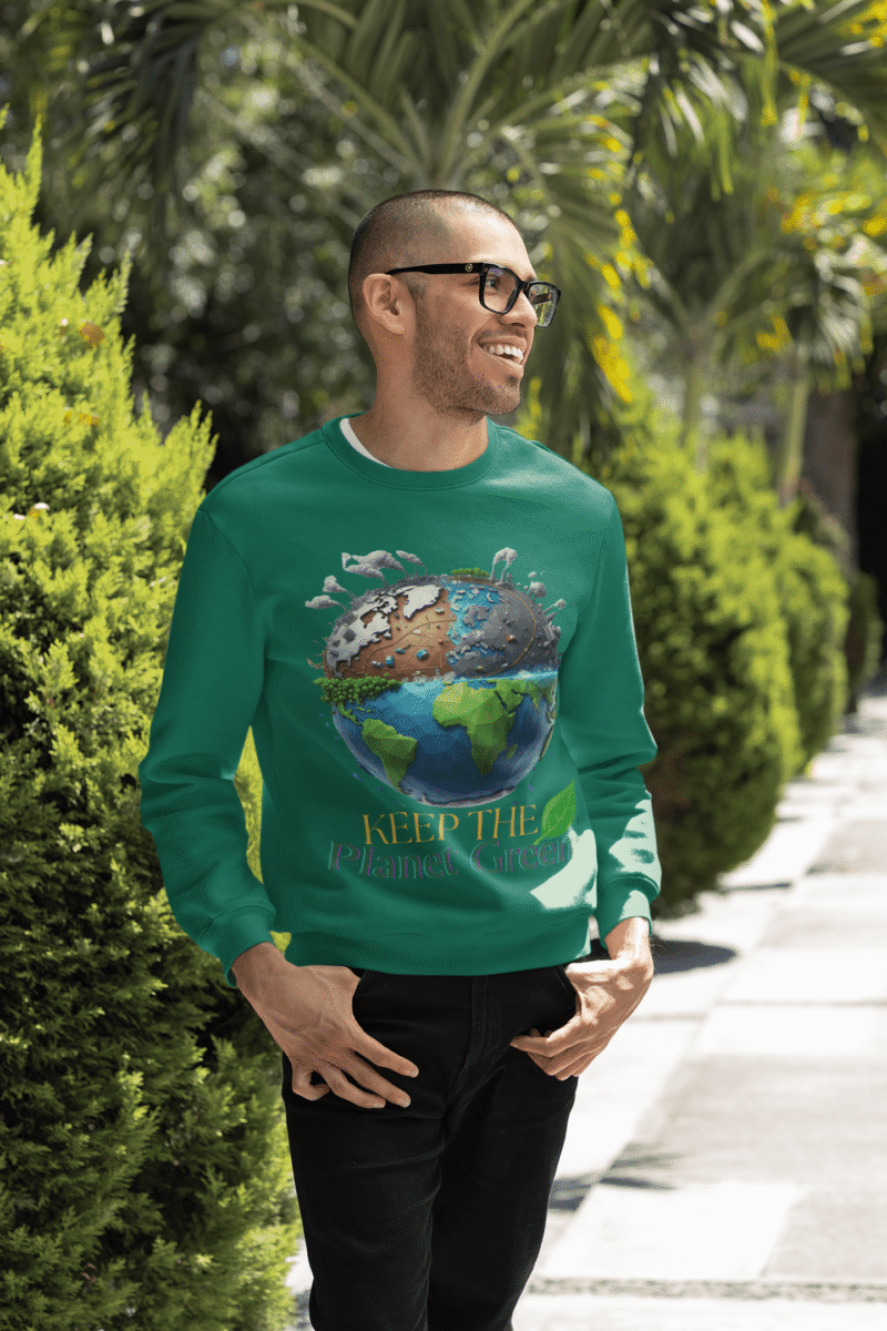 A smiling man wearing a bottle green PodLyft Earth Day Sweatshirt, featuring the "Keep the Planet Green" Earth design, posing outdoors.