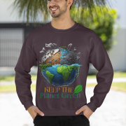 Front view of a male model in a comfortable dark brown PodLyft Earth Day Sweatshirt. The eye-catching design prominently displays a globe divided, showing a polluted cityscape on one side and a lush green landscape on the other, accompanied by the environmental message "KEEP THE Planet Green.