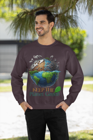 Front view of a male model in a comfortable dark brown PodLyft Earth Day Sweatshirt. The eye-catching design prominently displays a globe divided, showing a polluted cityscape on one side and a lush green landscape on the other, accompanied by the environmental message "KEEP THE Planet Green.