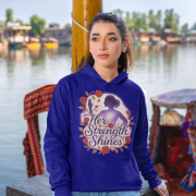 A young woman, possibly of East Asian descent, with dark hair, wearing a navy blue PodLyft women's empowered hoodie. The hoodie features an abstract graphic with geometric shapes and subtle lines in shades of purple and pink, conveying a message of empowerment. She is looking directly at the camera with a subtle smile, standing against a blurred grey background.