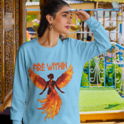 A young woman, possibly of Caucasian descent with light brown hair, wearing a baby blue PodLyft women's Fire Within sweatshirt. The sweatshirt features a graphic of a human heart with stylized flames emanating from its top, and the text "FIRE WITHIN" written above and below it. She is looking directly at the camera with a subtle smile, standing against a plain light grey background.