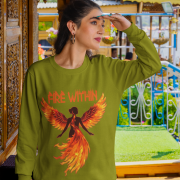 A young woman, possibly of Caucasian descent with light brown hair, wearing an olive green PodLyft women's Fire Within sweatshirt. The sweatshirt features a graphic of a human heart with stylized flames emanating from its top, and the text "FIRE WITHIN" written above and below it. She is looking directly at the camera with a subtle smile, standing against a plain light grey background.