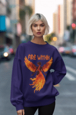 A young woman, possibly of Caucasian descent with light brown hair, wearing a purple PodLyft women's Fire Within sweatshirt. The sweatshirt features a graphic of a human heart with stylized flames emanating from its top, and the text "SHE HAS FIRE WITHIN HER" written above and below it. She is looking directly at the camera with a subtle smile, standing against a plain light grey background.