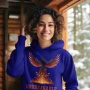 A young woman, possibly of Caucasian descent, with dark hair tied back, wearing a navy blue PodLyft women's Unbreakable Spirit hoodie. The hoodie features a graphic of a stylized, strong female figure in motion, with the word "UNBREAKABLE" across her. She is looking directly at the camera with a determined expression, standing against a plain light grey background.