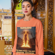 A young woman, possibly of South Asian descent, with long dark hair, wearing a coral PodLyft Yagyaseni Fireborn sweatshirt. The sweatshirt features a stylized graphic of a woman's silhouette against a fiery, abstract background, with the text "YAGYASENI" written below. She is looking directly at the camera with a confident expression, her arms crossed, standing against a plain light grey background.