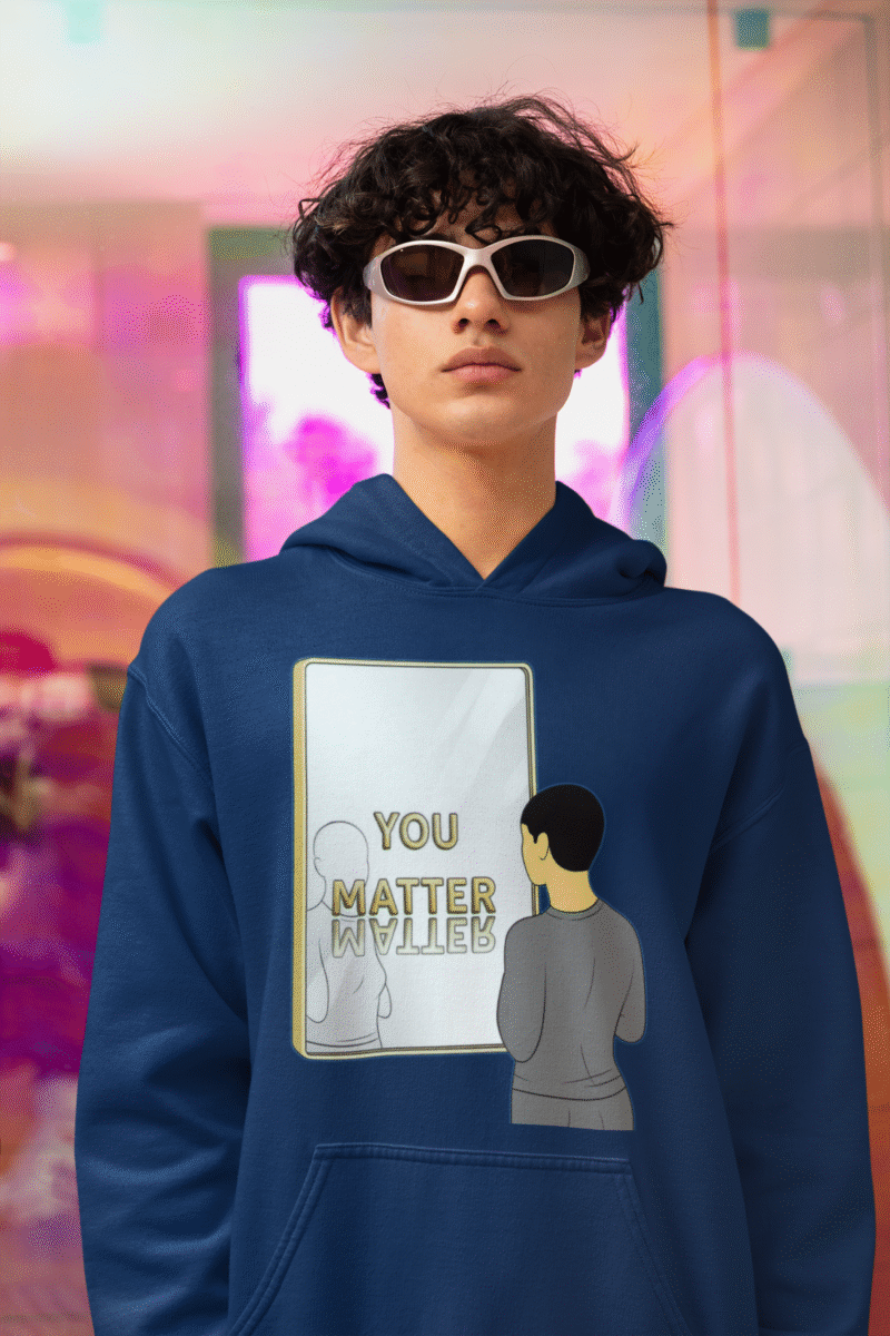 Navy blue You Matter hoodie for men by PodLyft featuring a minimalist design of a person standing in front of a gold-framed mirror with the words "YOU MATTER" and its reflection, promoting self-worth and empowerment.