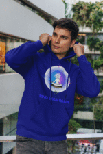 A young man, possibly of Caucasian descent, with short dark hair and a beard, wearing a navy blue PodLyft Men's Forging Your Character hoodie. The hoodie features a circular graphic with the letters "FYC" prominently in the center, surrounded by text that includes "Find Your Calm." He is looking directly at the camera with a confident expression, standing against a plain light grey background.