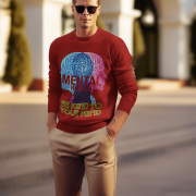 A young man, possibly of Caucasian descent, with short dark hair and a beard, wearing a maroon PodLyft Mental Wellness Sweatshirt for men. The sweatshirt features a circular graphic with the letters "BKTYM" prominently in the center, surrounded by the phrase "BE KIND TO YOUR MIND." He is looking directly at the camera with a confident expression, standing against a plain light grey background.