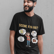 A young man, possibly of Caucasian descent, with short dark hair and a beard, wearing a black t-shirt. The t-shirt features a humorous graphic with the Hindi text "SCENE KYA HAI" and a stylized question mark. He is looking directly at the camera with a confident expression, standing against a plain light grey background.