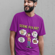 A young man, possibly of Caucasian descent, with short dark hair and a beard, wearing a purple t-shirt. The t-shirt features a humorous graphic with the Hindi text "SCENE KYA HAI" and a stylized question mark. He is looking directly at the camera with a confident expression, standing against a plain light grey background.