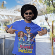 A young man, possibly of Caucasian descent, with short dark hair and a beard, wearing a royal blue PodLyft Pataka t-shirt. The t-shirt features a flirty graphic with the text, "Girl, were you born on Diwali? Because You are PATAKA." He is looking directly at the camera with a confident expression, standing against a plain light grey background.
