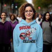 A young woman, possibly of Caucasian descent, with light brown hair pulled back, wearing a baby blue PodLyft Women's Break the Silence Hoodie. The hoodie features a graphic of a padlocked mouth with doves and butterflies bursting out, and the text "BREAK THE SILENCE" and "RAISE YOUR VOICE." She is looking directly at the camera with a confident expression, standing against a plain light grey background.