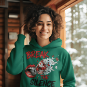 A young woman, possibly of Caucasian descent, with light brown hair pulled back, wearing a bottle green PodLyft Women's Break the Silence Hoodie. The hoodie features a graphic of a padlocked mouth with doves and butterflies bursting out, and the text "BREAK THE SILENCE" and "RAISE YOUR VOICE." She is looking directly at the camera with a confident expression, standing against a plain light grey background.