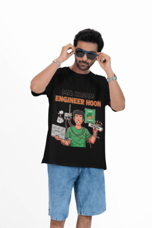 A man wearing a black PodLyft Men's Engineering Stress Tee against a white background, adjusting his sunglasses. The graphic on the shirt shows a stressed-out male engineer surrounded by broken electronics, wires, and coffee, with the Hindi text "MAA KASAM ENGINEER HOON" and a book titled "LEARN PYTHON 7 DAYS!