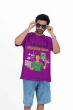 A man wearing a purple PodLyft Men's Engineering Stress Tee against a white background, adjusting his sunglasses. The graphic on the shirt shows a stressed-out male engineer surrounded by broken electronics, wires, and coffee, with the Hindi text "MAA KASAM ENGINEER HOON" and a book titled "LEARN PYTHON 7 DAYS!