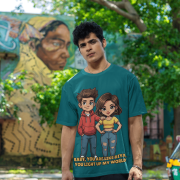 A young man, possibly of Caucasian descent, with short dark hair and a beard, wearing a petrol blue PodLyft oversized Light Up T-shirt. The t-shirt features a graphic of a cartoon-style couple and the flirty text, "Baby You Are Like Diya, You Light Up My World." He is looking directly at the camera with a confident expression, standing against a plain light grey background.