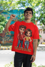 A young man, possibly of Caucasian descent, with short dark hair and a beard, wearing a red PodLyft oversized Light Up T-shirt. The t-shirt features a graphic of a cartoon-style couple and the flirty text, "Baby You Are Like Diya, You Light Up My World." He is looking directly at the camera with a confident expression, standing against a plain light grey background.