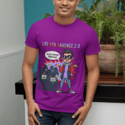 A young man, possibly of Caucasian descent, with short dark hair and a beard, wearing a purple PodLyft Log Kya Kahenge T-shirt. The t-shirt features a funny social parody graphic with Hindi text. He is looking directly at the camera with a confident expression, standing against a plain light grey background.