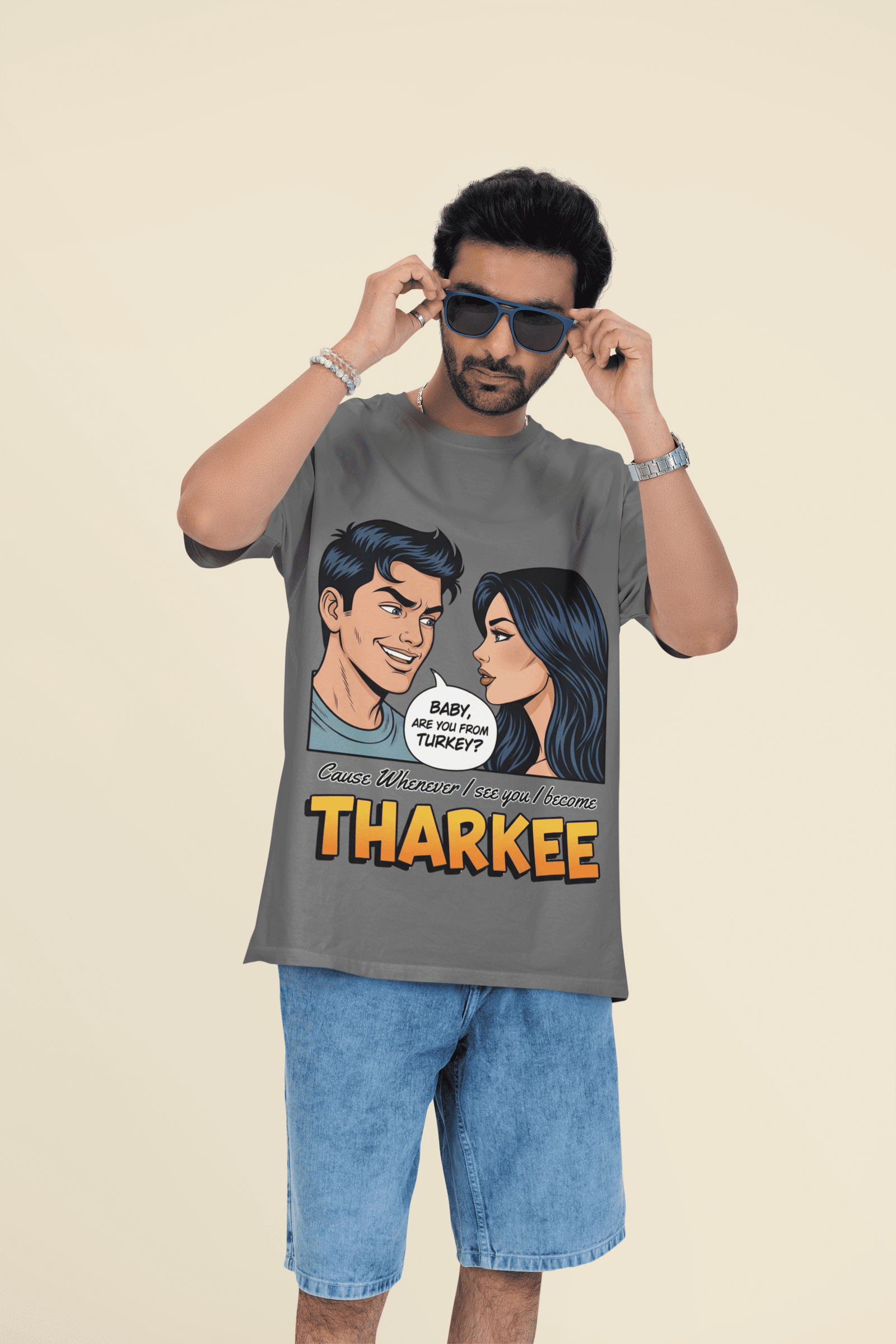 Man wearing a PodLyft's Tharkee T-shirt with a comic-style design and the text “Baby, are you from Turkey? Cause whenever I see you I become Tharkee,” paired with blue denim shorts.