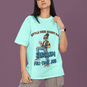 Woman wearing PodLyft Women's Full-Time Sarcasm Tee in mint green featuring cartoon character design with 'Style Meri Hobby Hai' and 'Sarcasm Full-Time Job' text, paired with gray cargo pants against purple background