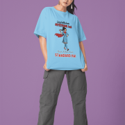 Baby Blue Desi Swag Oversized Tee by PodLyft. A model wearing sunglasses poses in a light blue oversized t-shirt with a funny "Attitude vs Standard" graphic print.